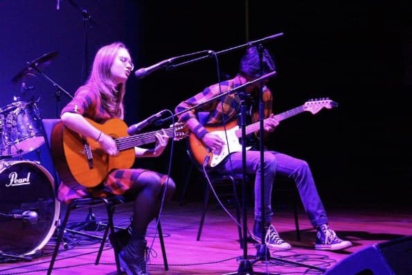 The duo playing two guitars on stage