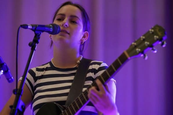 Guitarist in a striped top singing